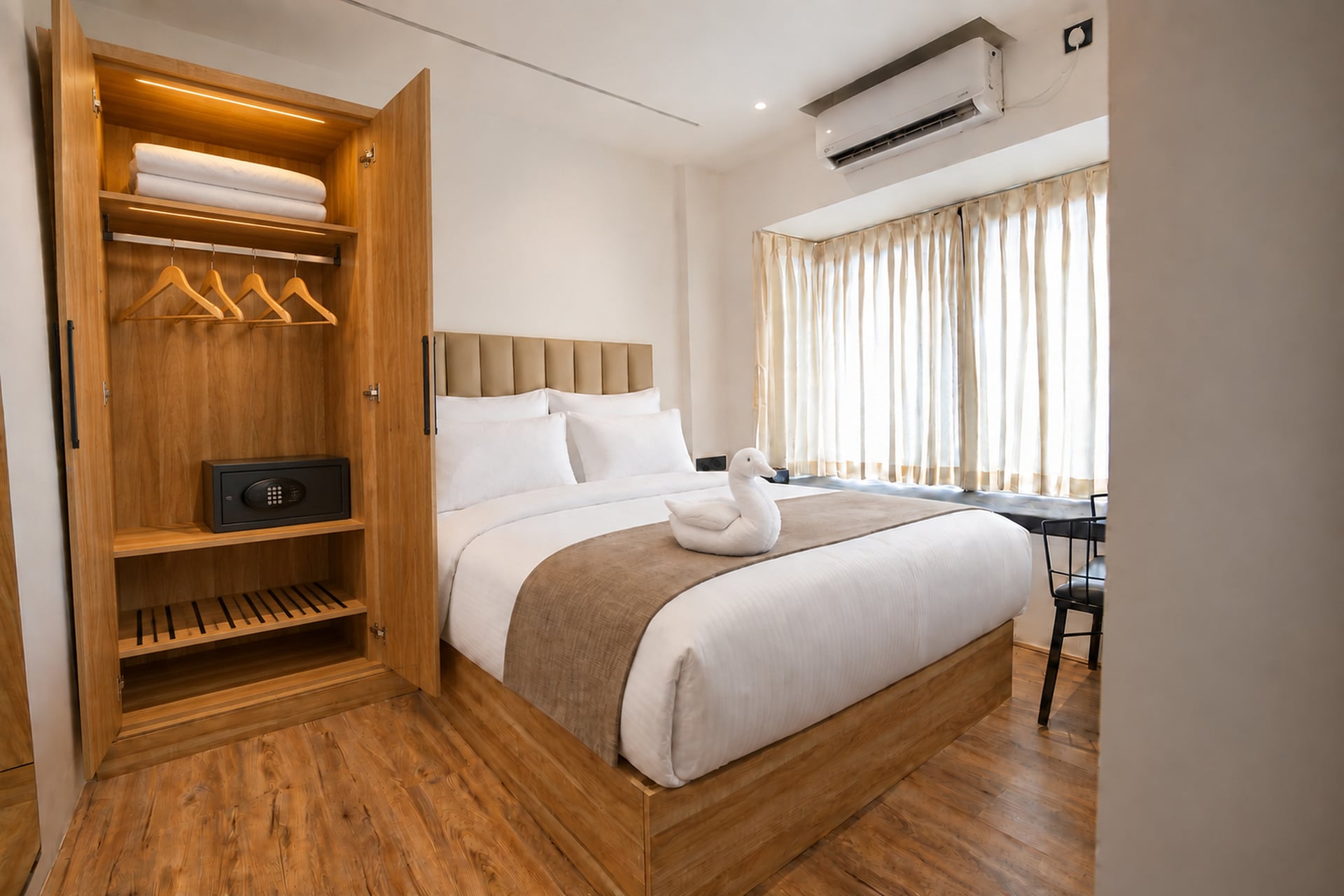 Guest room with an open timber wardrobe, hangers and an in-room safe